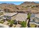 A high aerial view of a home in a suburban neighborhood, surrounded by desert landscaping and mountain views at 145 Langley Hill Ave, Henderson, NV 89002
