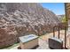 Backyard features a rock wall and fire pit, offering a tranquil outdoor retreat at 145 Langley Hill Ave, Henderson, NV 89002