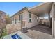 Outdoor patio with a covered area, built-in grill, fire pit, and low-maintenance landscaping at 145 Langley Hill Ave, Henderson, NV 89002
