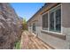 Backyard features low-maintenance turf, wood deck, and a large rock formation at 145 Langley Hill Ave, Henderson, NV 89002