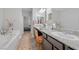 Bathroom with granite countertops, dual sinks, a bathtub, and a tiled floor at 145 Langley Hill Ave, Henderson, NV 89002