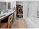 Bathroom with granite countertops, dual sinks, shower, and bathtub at 145 Langley Hill Ave, Henderson, NV 89002