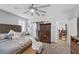 Bedroom with gray walls, carpet, ceiling fan, and access to en suite at 145 Langley Hill Ave, Henderson, NV 89002