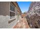 Exterior view showcases wooden deck, stucco facade, and adjacent rock formation at 145 Langley Hill Ave, Henderson, NV 89002