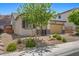 Single-Gathering home featuring desert landscaping, a two-car garage, and charming architectural details at 145 Langley Hill Ave, Henderson, NV 89002