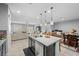Open-concept kitchen flows into living area, featuring granite countertops, stainless appliances, and eat-in island at 145 Langley Hill Ave, Henderson, NV 89002