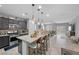 Open-concept kitchen with granite countertops, stainless steel appliances, and an eat-in island at 145 Langley Hill Ave, Henderson, NV 89002