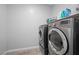 Laundry room with modern, front-loading washer and dryer units at 145 Langley Hill Ave, Henderson, NV 89002