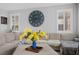 Cozy living room with plush sectional sofa, large decorative clock, and bright natural light from shuttered windows at 145 Langley Hill Ave, Henderson, NV 89002