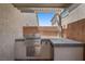 Covered outdoor kitchen features a stainless steel grill and ample counter space at 145 Langley Hill Ave, Henderson, NV 89002