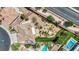 An aerial view shows the house's backyard with a pool, landscaped yard, and covered patio at 15 Imposing Knoll Ave, Henderson, NV 89002
