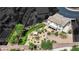 A home featuring a landscaped backyard with a grass lawn, patio and desert landscaping at 15 Imposing Knoll Ave, Henderson, NV 89002