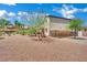 Expansive backyard featuring desert landscaping, a pet enclosure and partial view of home's exterior at 15 Imposing Knoll Ave, Henderson, NV 89002