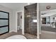 Modern bathroom showcasing a glass shower, wood floors, and stylish fixtures at 15 Imposing Knoll Ave, Henderson, NV 89002
