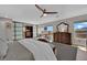 Bright bedroom with wood floors, windows with views, wardrobe closet, and ceiling fan at 15 Imposing Knoll Ave, Henderson, NV 89002