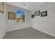 Cozy bedroom with neutral walls, carpet flooring, and a large window offering natural light at 15 Imposing Knoll Ave, Henderson, NV 89002