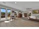 Bright bedroom featuring wood floors, windows with mountain views, ceiling fan and ensuite bath at 15 Imposing Knoll Ave, Henderson, NV 89002