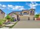 Charming two-story home with a three car garage, stone steps and green landscaping at 15 Imposing Knoll Ave, Henderson, NV 89002
