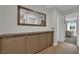 Hallway with built-in storage leading to a bedroom with lots of natural light at 15 Imposing Knoll Ave, Henderson, NV 89002