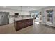 Spacious kitchen featuring stainless steel appliances, granite counters, and an island with seating at 15 Imposing Knoll Ave, Henderson, NV 89002