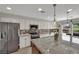 Bright kitchen with stainless steel refrigerator, gas range and a large island with seating and a sink at 15 Imposing Knoll Ave, Henderson, NV 89002