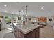Spacious kitchen island with granite countertops, a sink, and stylish pendant lighting at 15 Imposing Knoll Ave, Henderson, NV 89002