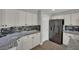 Well-equipped kitchen featuring stainless steel refrigerator and a view of the dining area at 15 Imposing Knoll Ave, Henderson, NV 89002