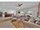 Bright open-concept living room with multiple windows and views of the spacious kitchen at 15 Imposing Knoll Ave, Henderson, NV 89002