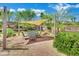 Inviting patio features a shade awning, string lights, and beautiful desert landscaping at 15 Imposing Knoll Ave, Henderson, NV 89002