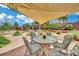 Outdoor patio area with table, chairs and views of the landscaped backyard at 15 Imposing Knoll Ave, Henderson, NV 89002
