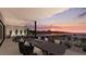 Outdoor dining area with mountain views at sunset at 1516 Pleasant Bay Ct, Henderson, NV 89011
