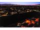 Dusk aerial view of the community showing the layout and city lights in the background at 1557 Blue Sierra Ct, Henderson, NV 89074