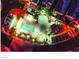 Night aerial image showcasing a community pool area with lounge chairs, well-lit parking, and palm trees at 1557 Blue Sierra Ct, Henderson, NV 89074