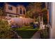 A tranquil backyard featuring an artificial lawn, seating area, and landscaped garden at 1557 Blue Sierra Ct, Henderson, NV 89074