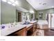 Large bathroom with double sink, wood cabinets, oversized tub and separate shower at 1557 Blue Sierra Ct, Henderson, NV 89074