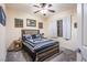 A cozy bedroom with a rustic wooden bed frame and black-and-white themed bedding at 1557 Blue Sierra Ct, Henderson, NV 89074
