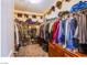 Walk-in closet with ample storage, including shelving and hanging space, for organized clothing and accessories at 1557 Blue Sierra Ct, Henderson, NV 89074