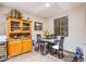 Cozy dining area features tile flooring, a glass table, and a charming wooden hutch at 1557 Blue Sierra Ct, Henderson, NV 89074