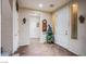 Bright entryway features tile flooring, a decorative tree, and neutral paint, creating a welcoming first impression at 1557 Blue Sierra Ct, Henderson, NV 89074