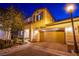 Two-story home with a brick driveway, a two-car garage, shutters, and a manicured front yard at 1557 Blue Sierra Ct, Henderson, NV 89074