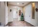 Spacious foyer with tile flooring, neutral walls, decorative accents, and a staircase at 1557 Blue Sierra Ct, Henderson, NV 89074
