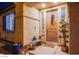 Charming covered front porch with unique decor, including a decorative bench, plants, and a welcoming door at 1557 Blue Sierra Ct, Henderson, NV 89074