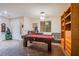 Recreation room featuring a pool table, built-in shelves, and a neutral color palette at 1557 Blue Sierra Ct, Henderson, NV 89074