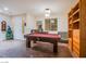 Spacious game room with a pool table, tile flooring, and ample natural light, perfect for entertaining at 1557 Blue Sierra Ct, Henderson, NV 89074