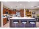 Modern kitchen with a center island, stainless steel appliances, and dark wood cabinets at 1557 Blue Sierra Ct, Henderson, NV 89074