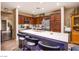 Modern kitchen features dark wood cabinets, stainless appliances, and a spacious white quartz island with bar seating at 1557 Blue Sierra Ct, Henderson, NV 89074