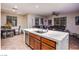 Open concept kitchen features a quartz island with sink, stainless appliances, and an eat-in dining area next to a living area at 1557 Blue Sierra Ct, Henderson, NV 89074