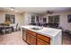 Bright kitchen with marble countertops, stainless steel appliances, and a spacious dining area at 1557 Blue Sierra Ct, Henderson, NV 89074