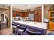 Well-equipped kitchen with dark wood cabinetry, stainless steel appliances, and bar seating at 1557 Blue Sierra Ct, Henderson, NV 89074