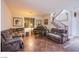 Cozy living room features plush seating, warm lighting, and staircase, ideal for relaxing and entertaining at 1557 Blue Sierra Ct, Henderson, NV 89074